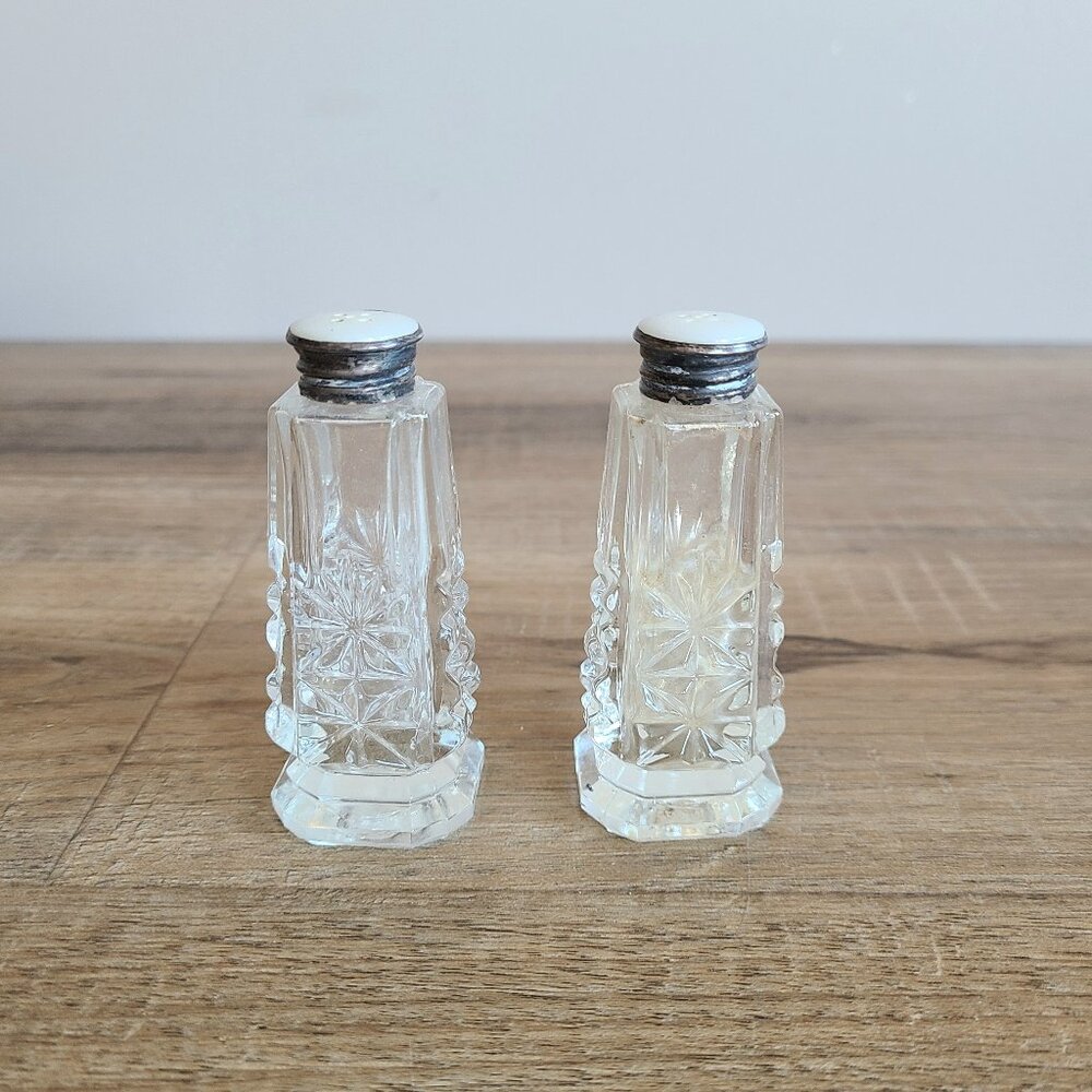 Antique crystal salt & pepper shakers sterling silver and mother of pearls lids.